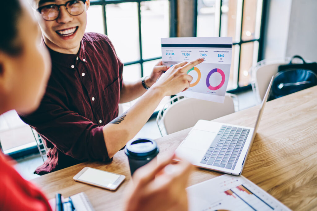ROI-Focused Digital Marketing: The Proven 2026 Guide 28 smiling coworkers checking graph in office 2026 01 09 07 27 45 utc scaled 1
